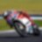 ducati superbike with rider cornering at speed on a racetrack