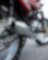 motorcycle parked on road with camera focused on the exhaust and wheels
